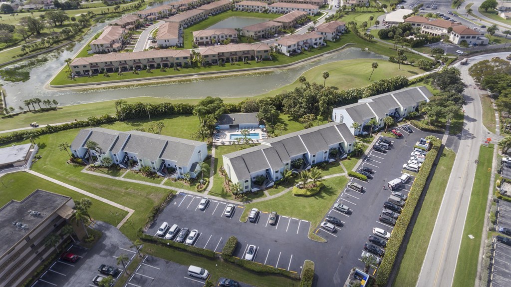 A bird's eye view of a residential area with houses and parked cars.